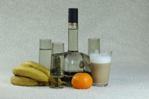 Still life with a bottle and glasses and fruits  
