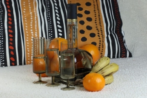Still life with a bottle and glasses and fruits  